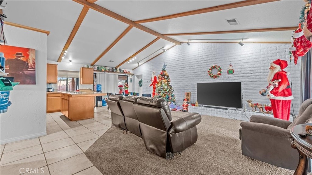 16043 St Timothy Road Apple Valley, CA 92307 - Photo 6 of 48 a living room with furniture and a flat screen tv