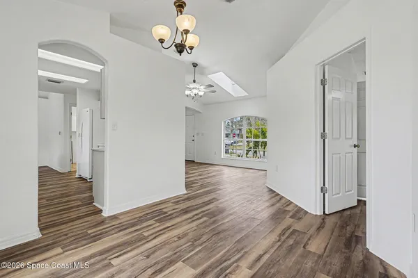 a kitchen with white cabinets and refrigerator