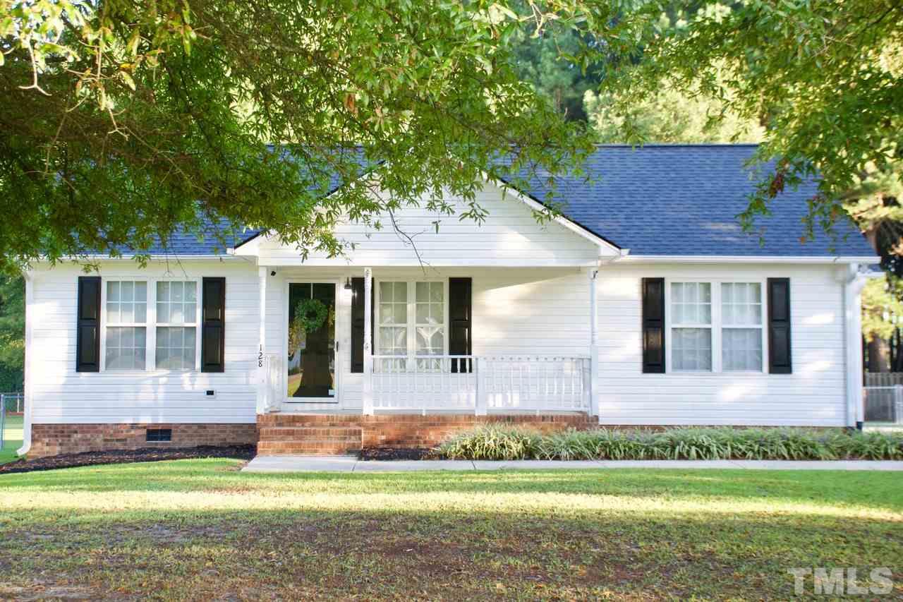 128 Forest Ridge Drive Willow Spring, NC 27592 - Photo 1 of 25 front view of a house with a yard