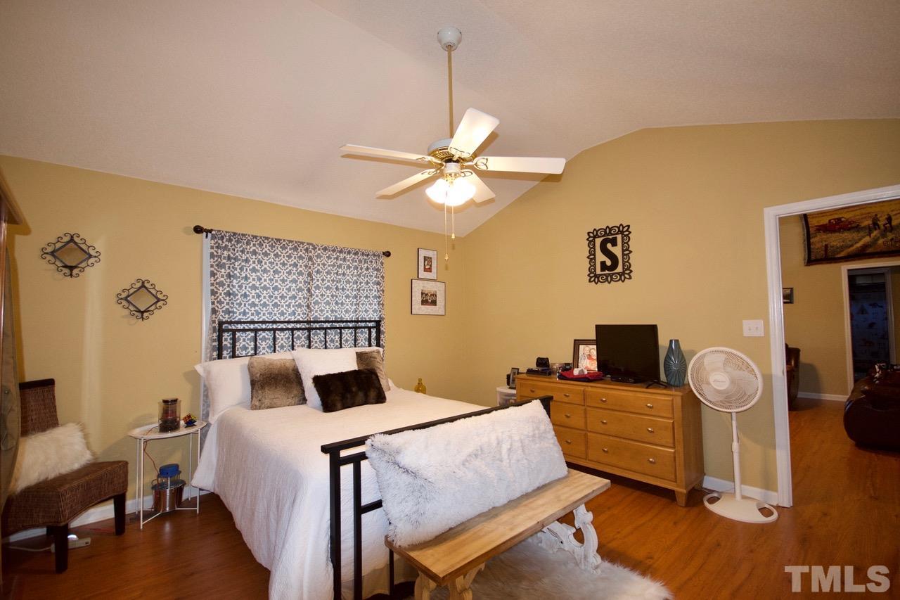 128 Forest Ridge Drive Willow Spring, NC 27592 - Photo 12 of 25 a bedroom with a bed and wooden floor