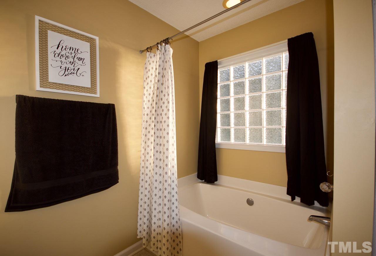 128 Forest Ridge Drive Willow Spring, NC 27592 - Photo 14 of 25 a bathroom with a bathtub and shower