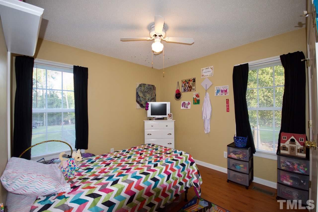 128 Forest Ridge Drive Willow Spring, NC 27592 - Photo 17 of 25 a bedroom with a bed and a flat screen tv