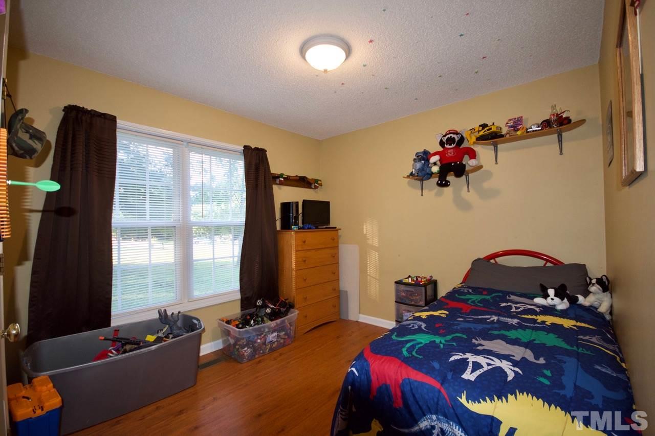 128 Forest Ridge Drive Willow Spring, NC 27592 - Photo 19 of 25 a bedroom with bed and a window