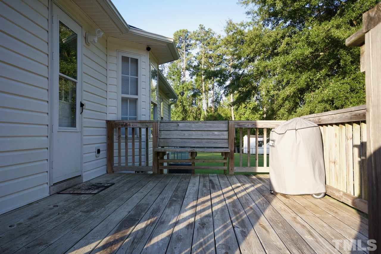 128 Forest Ridge Drive Willow Spring, NC 27592 - Photo 20 of 25 a view of a wooden deck and a backyard