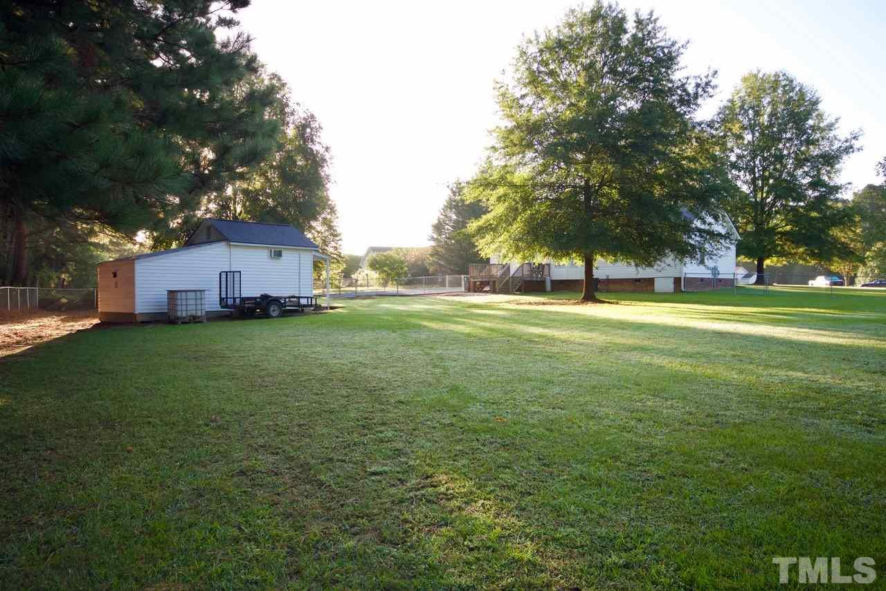 128 Forest Ridge Drive Willow Spring, NC 27592 - Photo 23 of 25 a view of a field of grass and trees