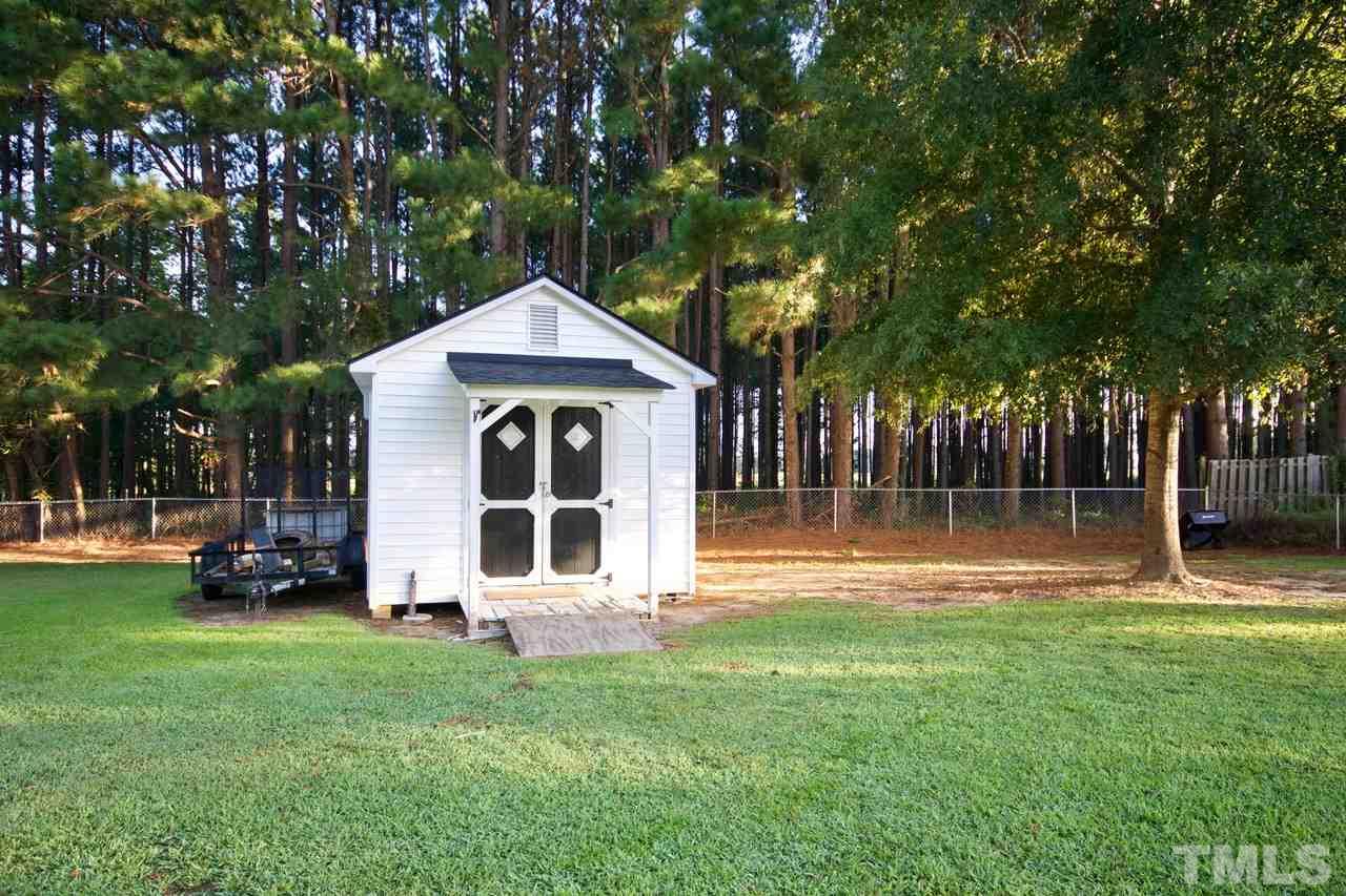 128 Forest Ridge Drive Willow Spring, NC 27592 - Photo 24 of 25 a front view of a house with a garden