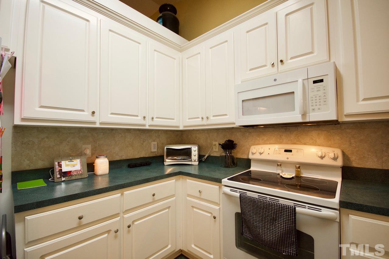 128 Forest Ridge Drive Willow Spring, NC 27592 - Photo 6 of 25 a kitchen with stainless steel appliances white cabinets and a sink