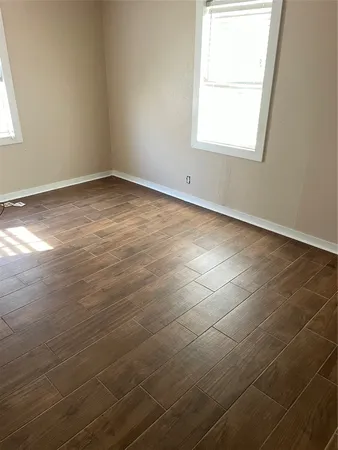 an empty room with a bathroom and a window
