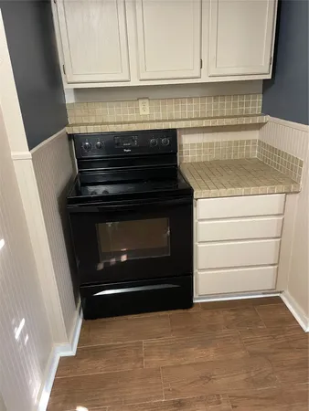 a stove top oven sitting inside of a kitchen