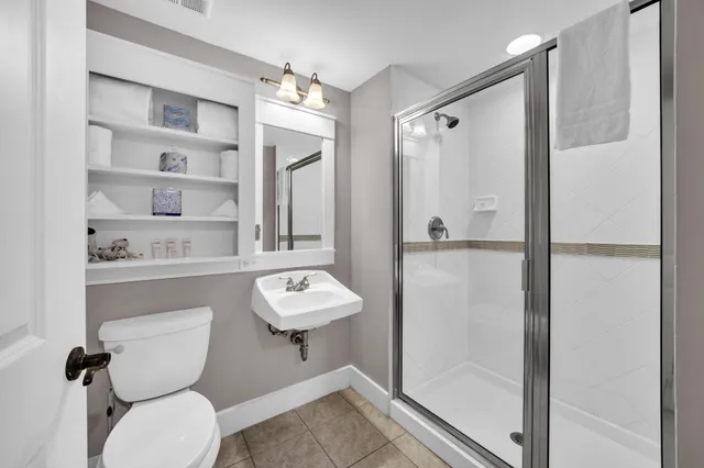 a bathroom with a toilet a sink and shower