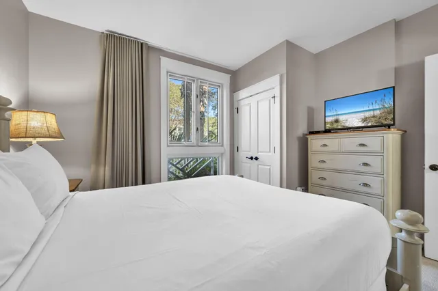 a bedroom with a bed and a television