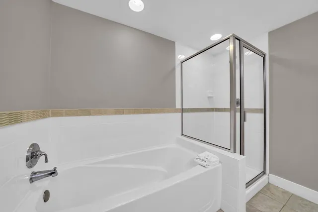 a bathroom with a tub and a shower