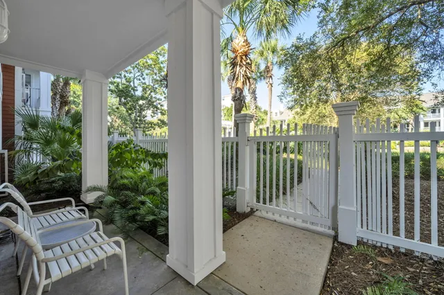 a view of a balcony with plants and wooden fence