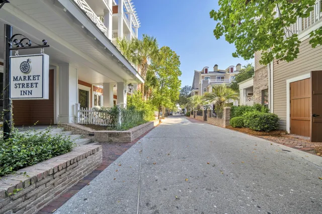 a view of a house with a yard and potted plants