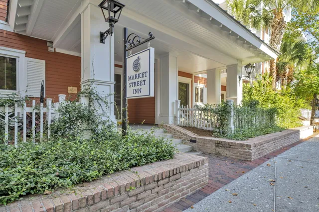 a view of a house with potted plants