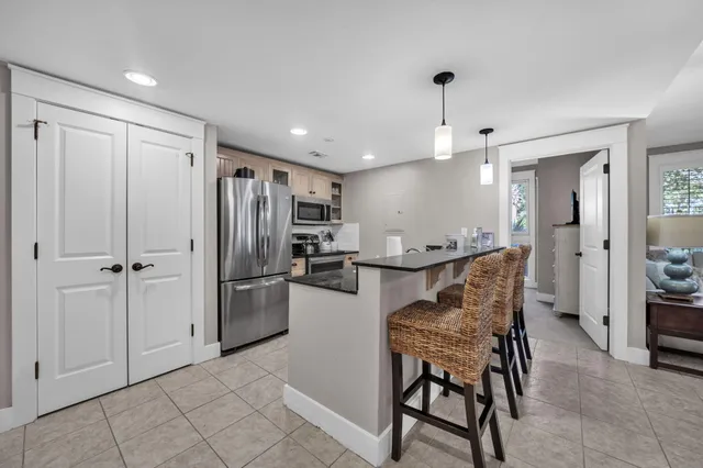 a view of kitchen with refrigerator and window