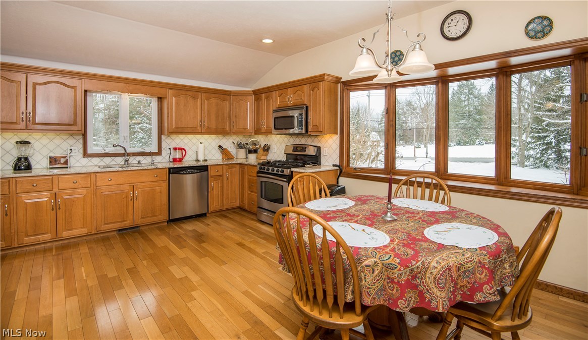 7844 Kinsman Road Novelty, OH 44072 - Photo 8 of 27 The spacious eat in kitchen with hardwood flooring and granite counter tops.
