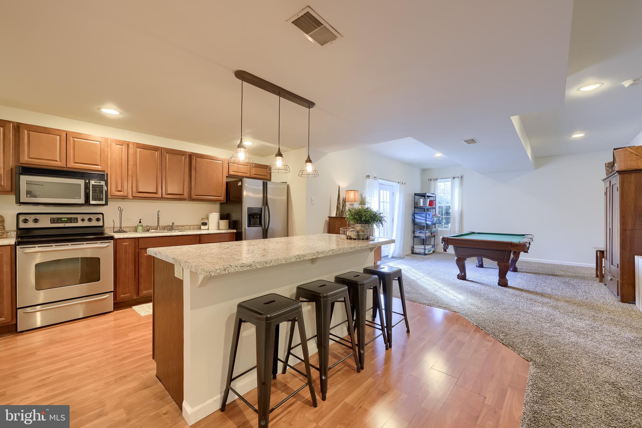 471 Shenks Ferry Road Conestoga, PA 17516 - Photo 61 of 105 a kitchen with stainless steel appliances kitchen island granite countertop a table chairs sink and cabinets