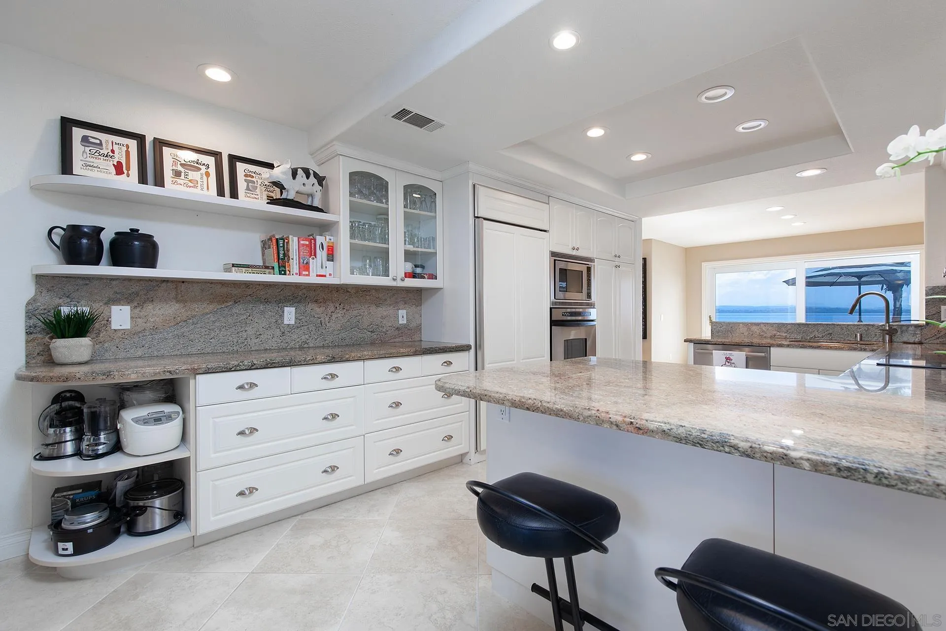 5 Aruba Bend Coronado, CA 92118 - Photo 18 of 40 a kitchen with cabinets and chairs