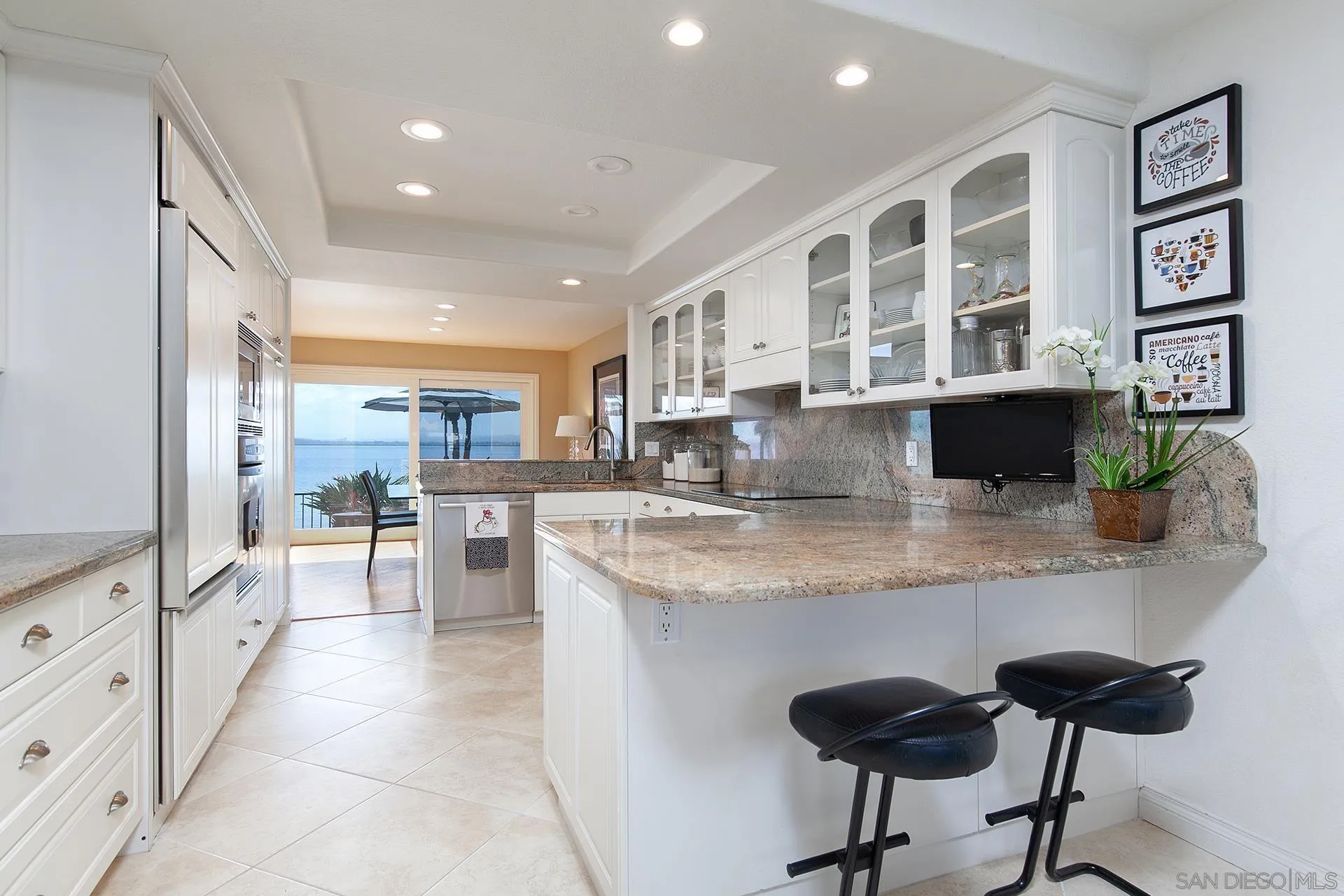 5 Aruba Bend Coronado, CA 92118 - Photo 19 of 40 a kitchen with stainless steel appliances granite countertop a stove and a refrigerator