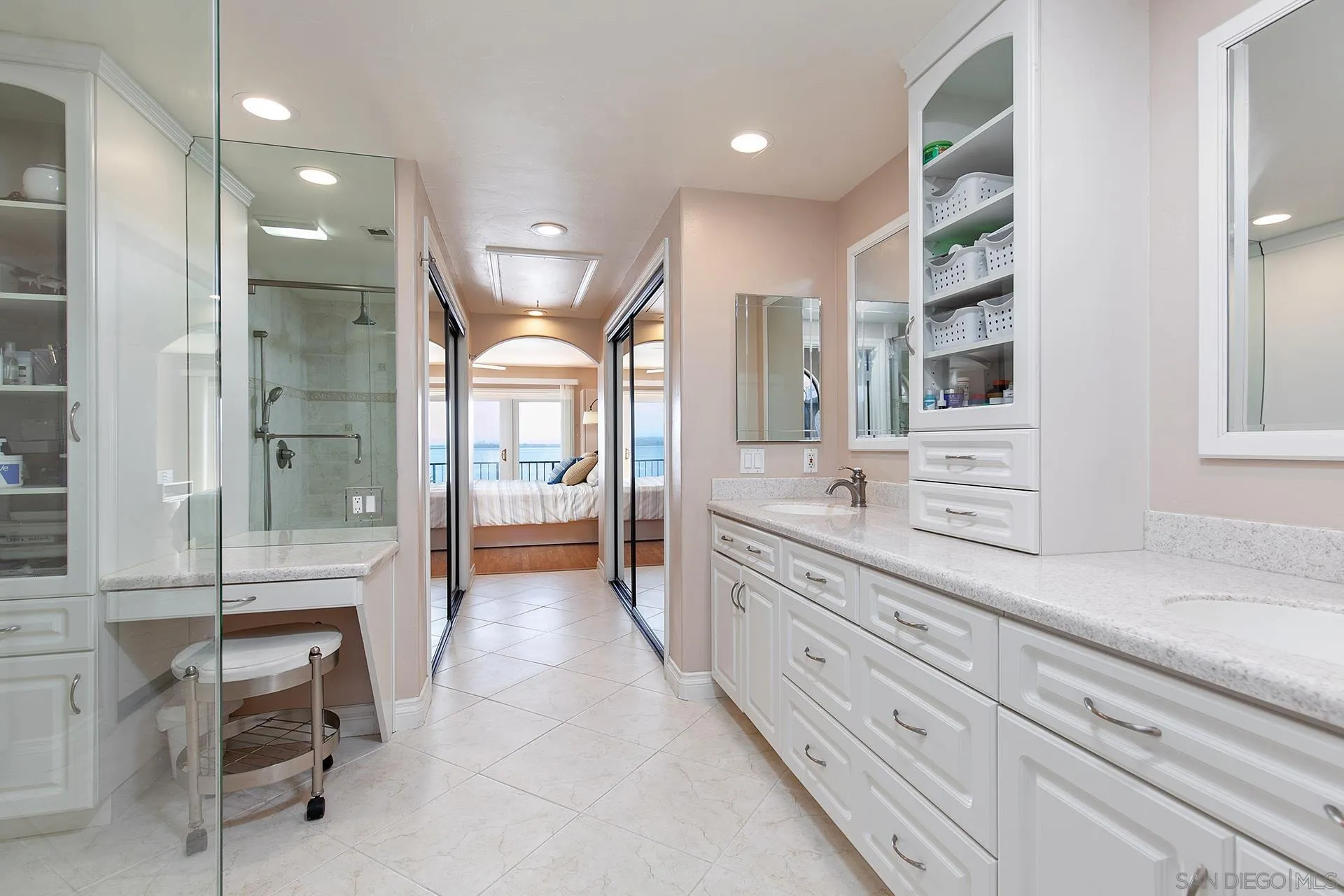 5 Aruba Bend Coronado, CA 92118 - Photo 34 of 40 a large bathroom with a large mirror vanity and shower