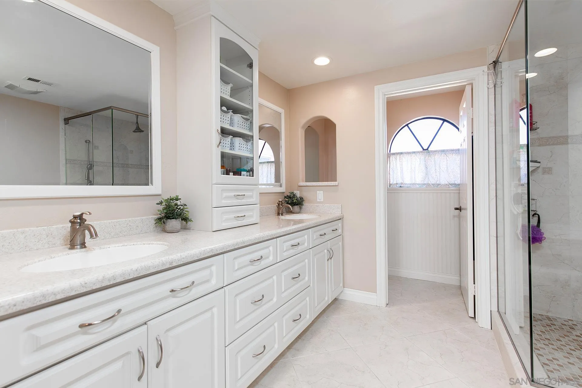 5 Aruba Bend Coronado, CA 92118 - Photo 35 of 40 a bathroom with a double vanity sink and a mirror