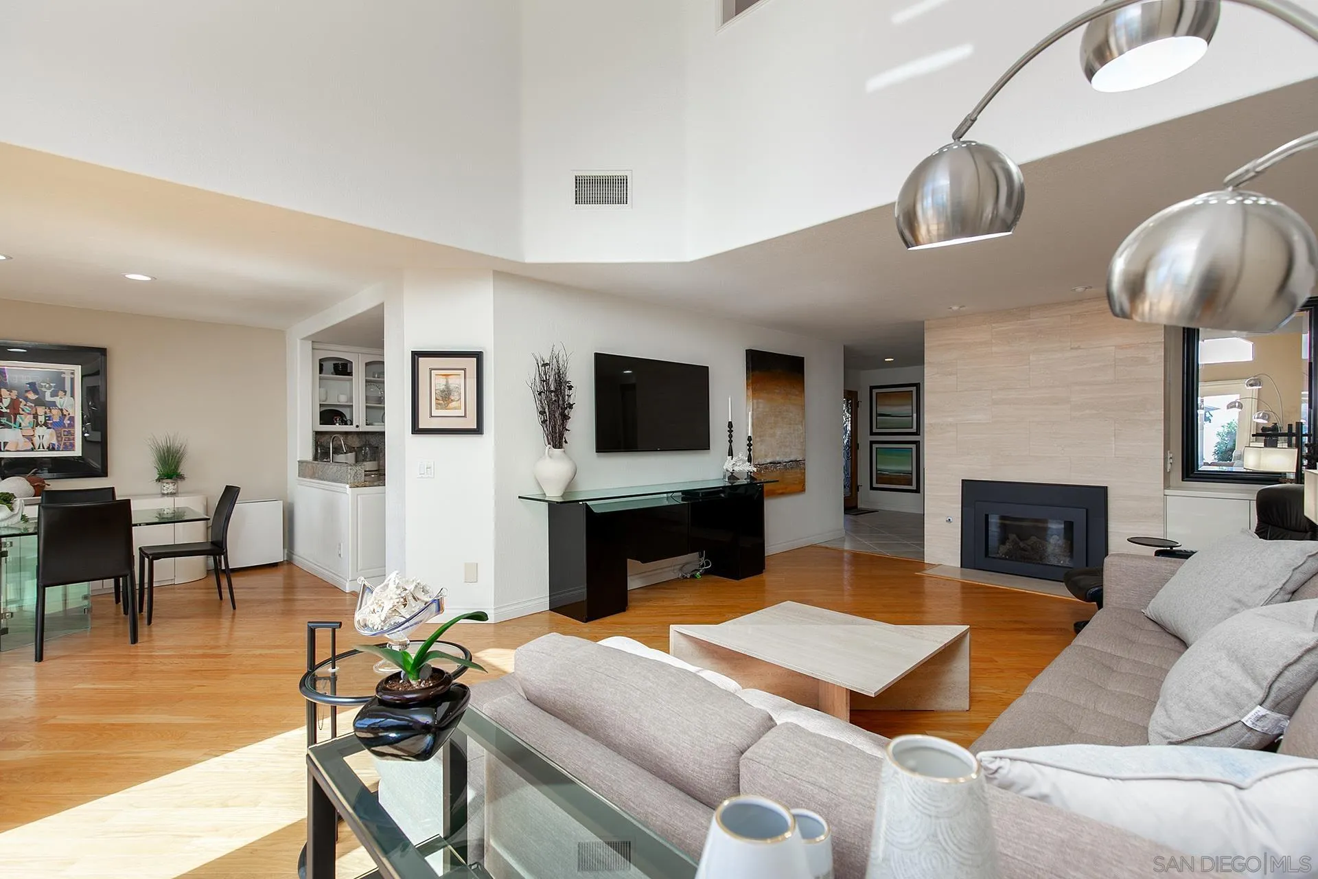 5 Aruba Bend Coronado, CA 92118 - Photo 10 of 40 a living room with furniture a flat screen tv and a fireplace