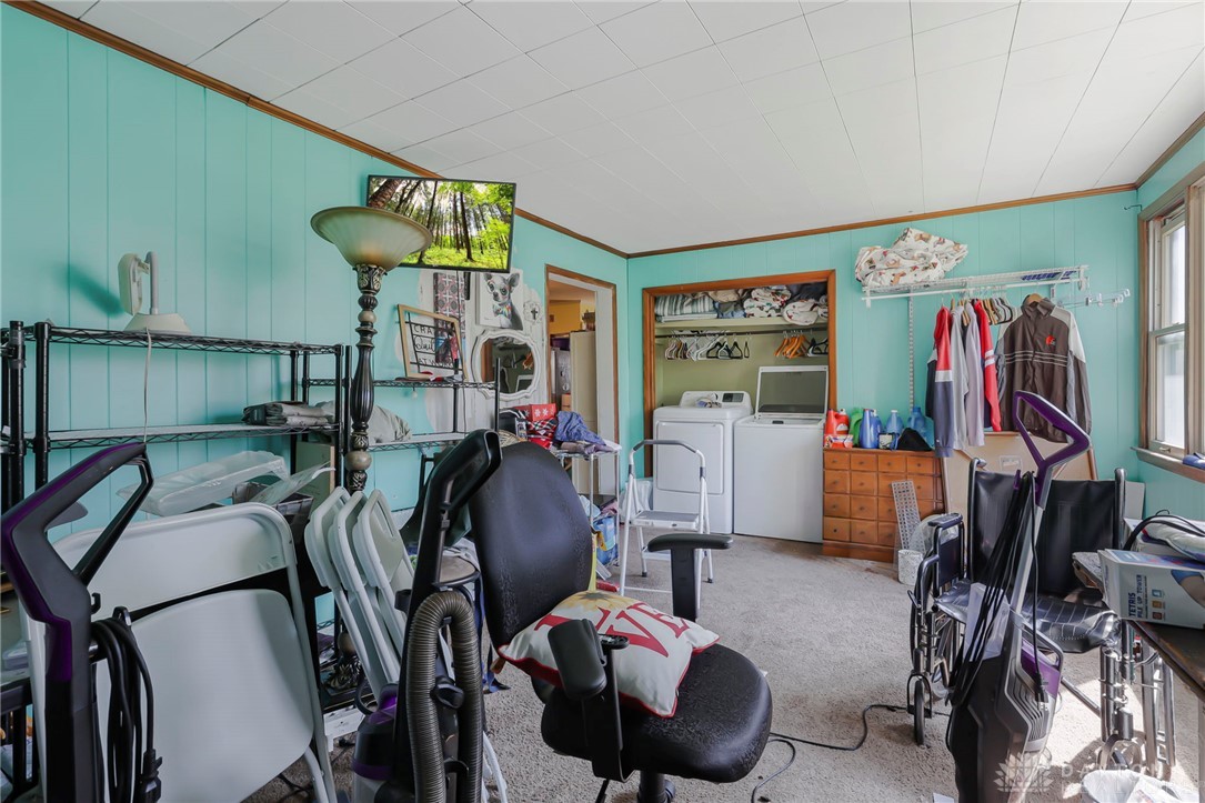 2390 Ridge Road Zanesville, OH 43701 - Photo 25 of 45 This dedicated laundry room features modern appliances and ample space for household tasks.