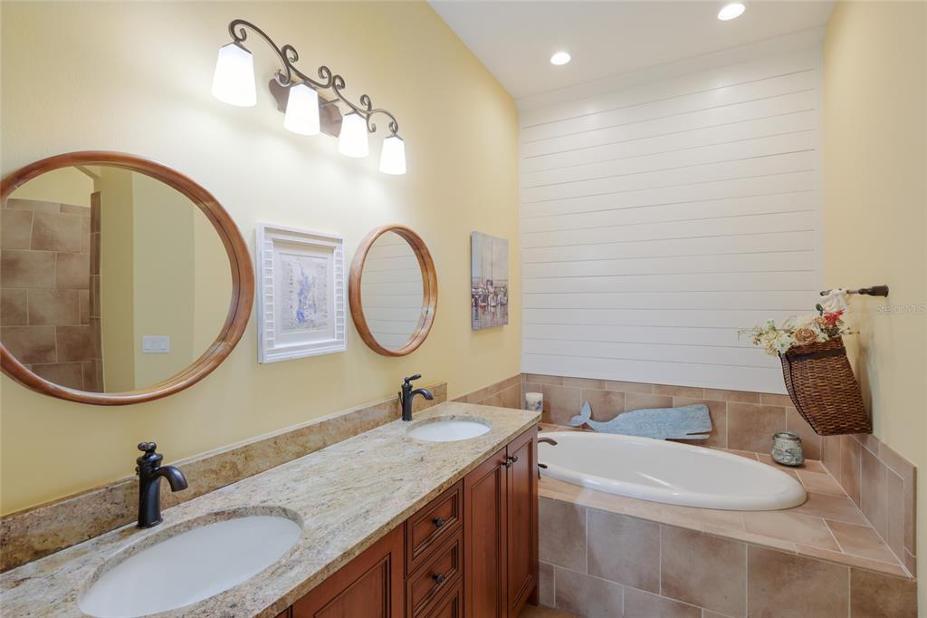5011 Tobermory Way Bradenton, FL 34211 - Photo 19 of 77 a bathroom with a granite countertop toilet a sink and a mirror