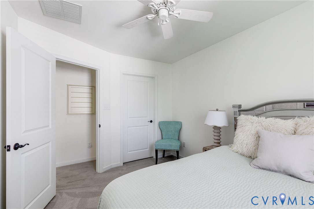 3900 Redbud Road Glen Allen, VA 23060 - Photo 32 of 37 a bedroom with a bed and a chandelier