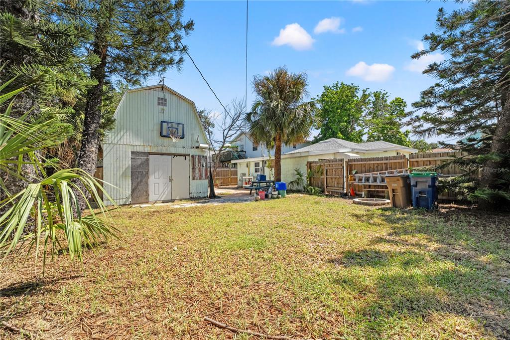 2600 1st Street Indian Rocks Beach, FL 33785 - Photo 26 of 40 a front view of house with yard and trees