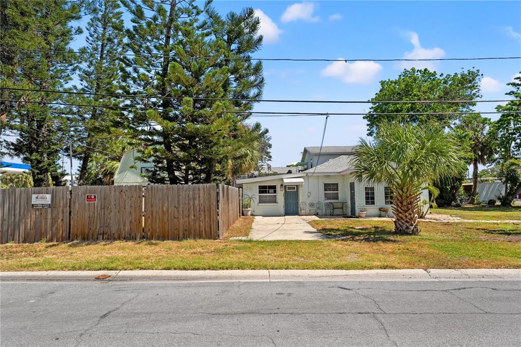 2600 1st Street Indian Rocks Beach, FL 33785 - Photo 34 of 40 a front view of a house with a yard and trees