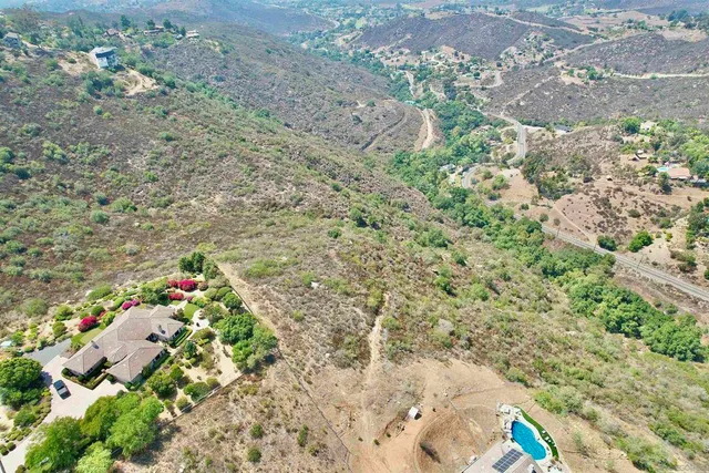 a backyard of a house with a yard and outdoor seating