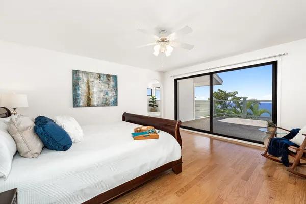 a bedroom with a bed and a large mirror next to a large window