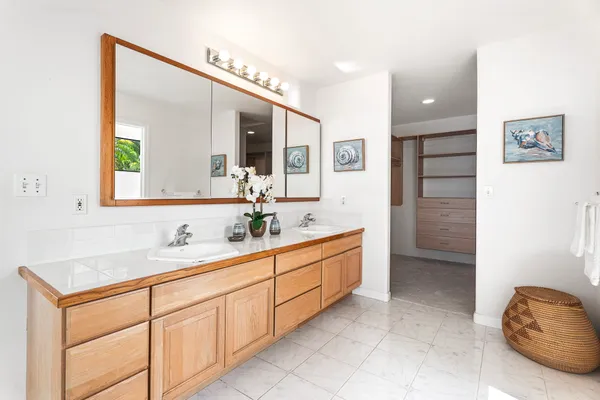 a bathroom with a double vanity sink and a mirror