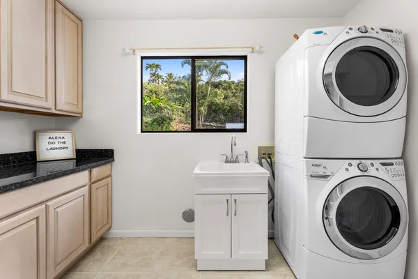 a utility room with sink dryer and washer