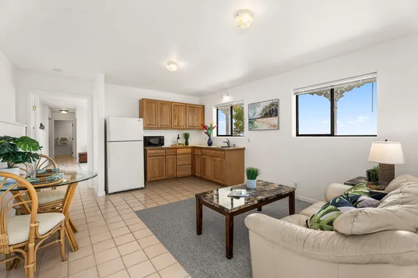 a living room with furniture and kitchen view