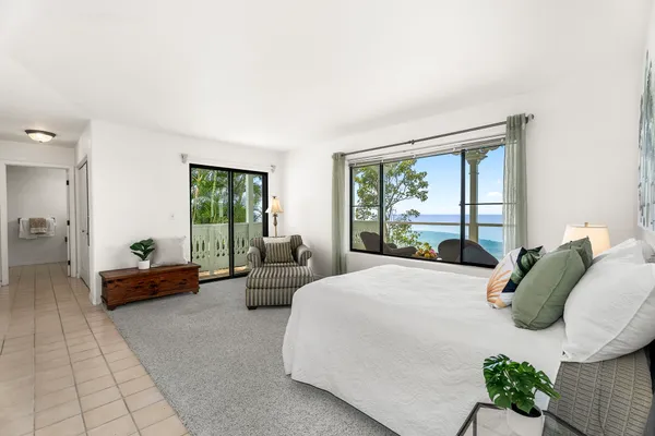 a bedroom with a bed and glass window