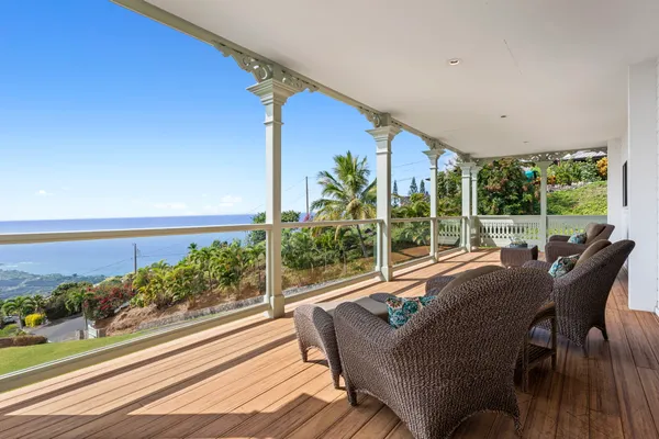 a view of a patio with lawn chairs floor to ceiling window and wooden floor