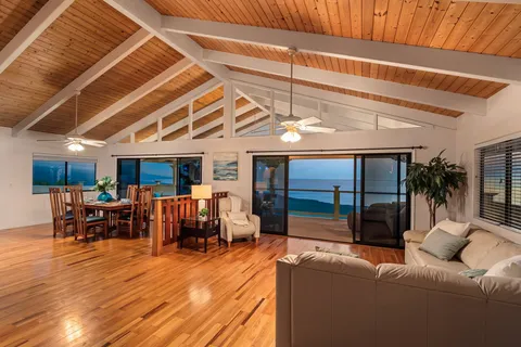 a living room with furniture a fireplace and a chandelier