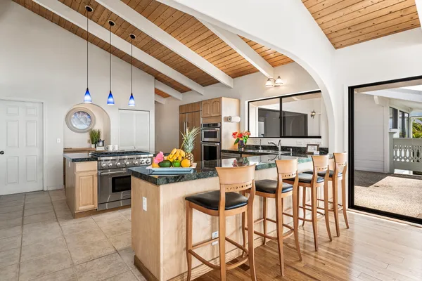 a kitchen with granite countertop a sink appliances and cabinets