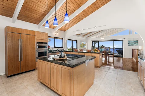 a kitchen with stainless steel appliances granite countertop a sink and cabinets
