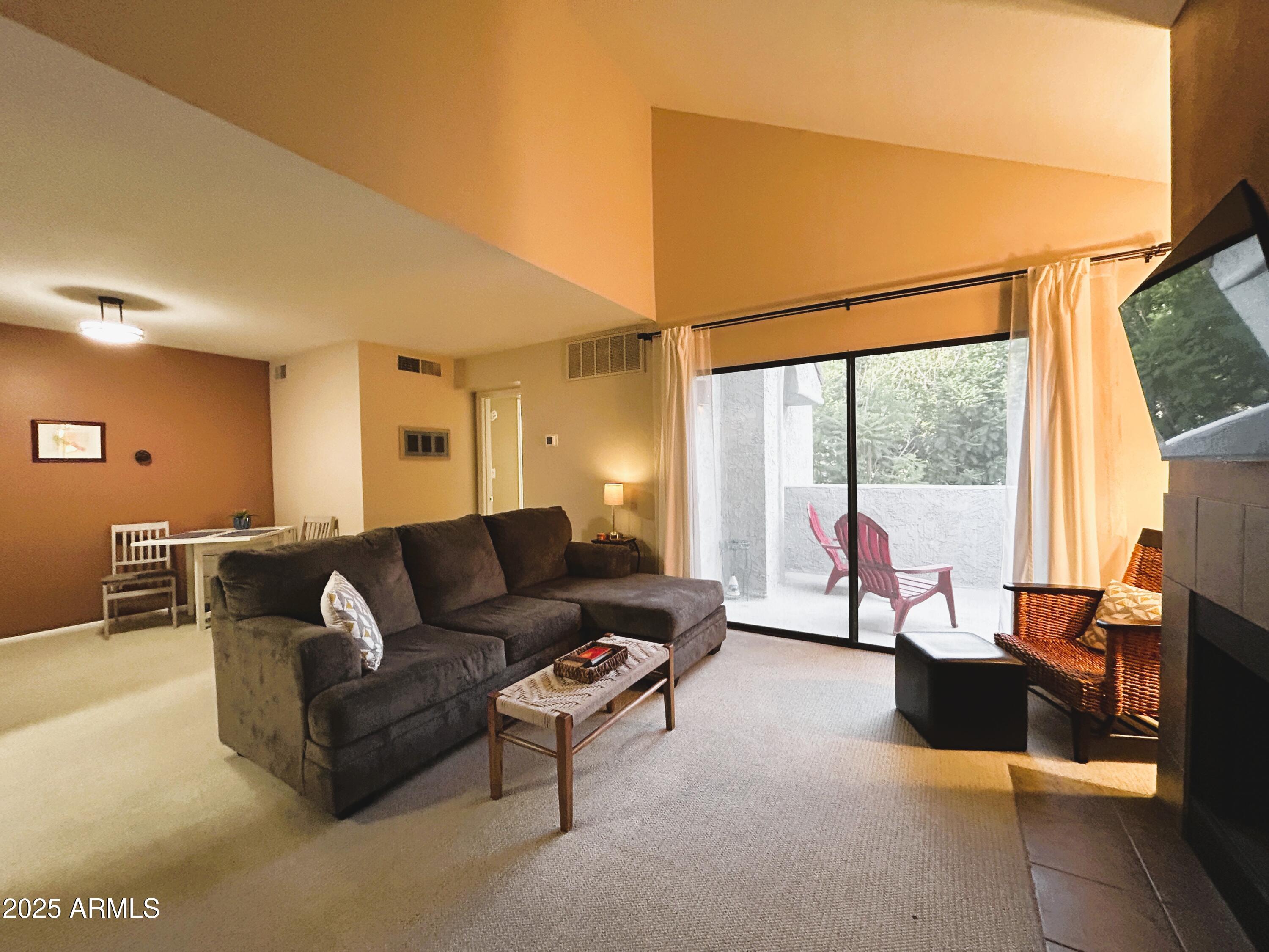 a living room with furniture and a large window