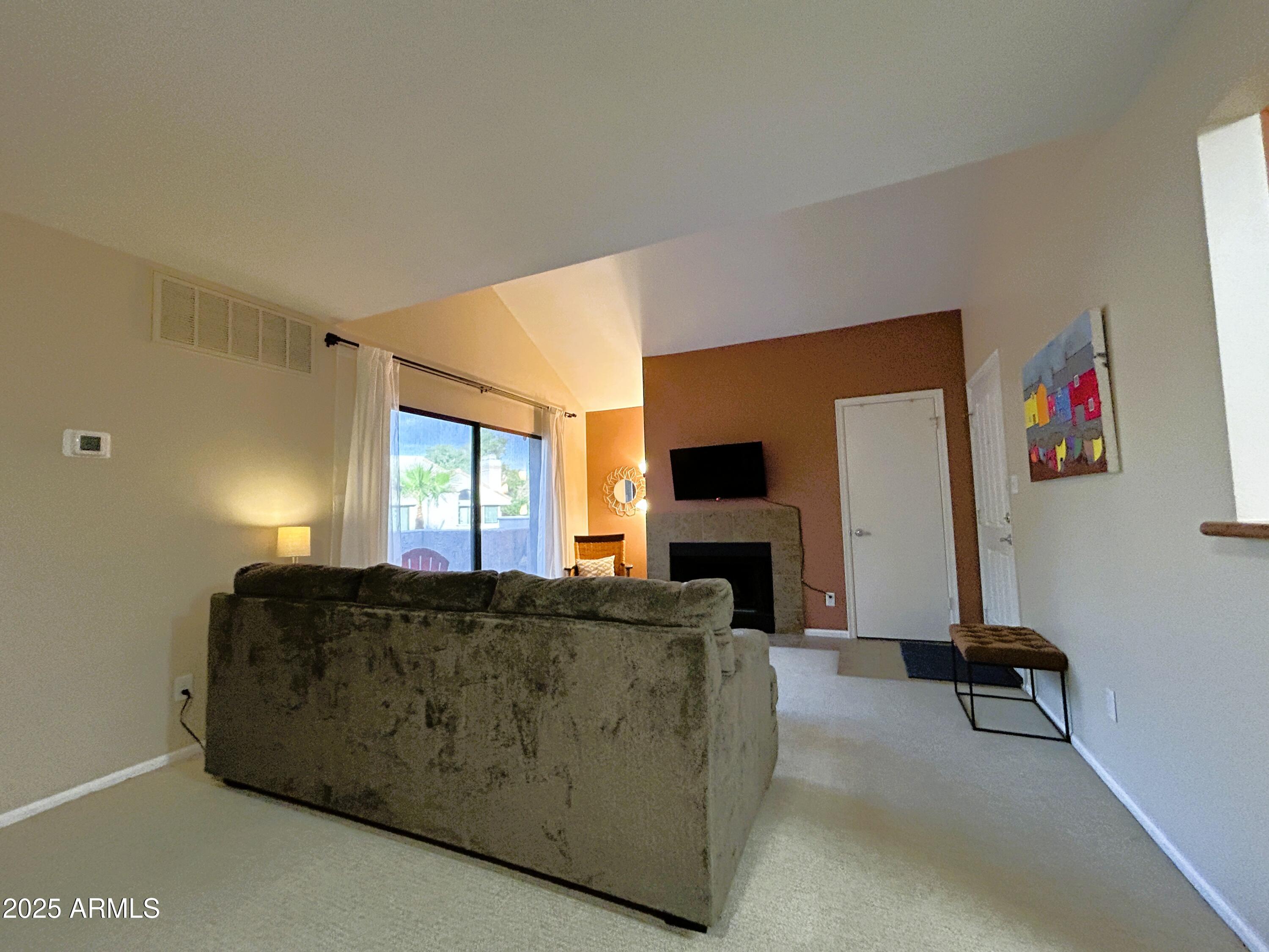 10055 East Mountainview Lake Drive, Unit 2059 Scottsdale, AZ 85258 - Photo 11 of 34 a living room with furniture a flat screen tv and a window