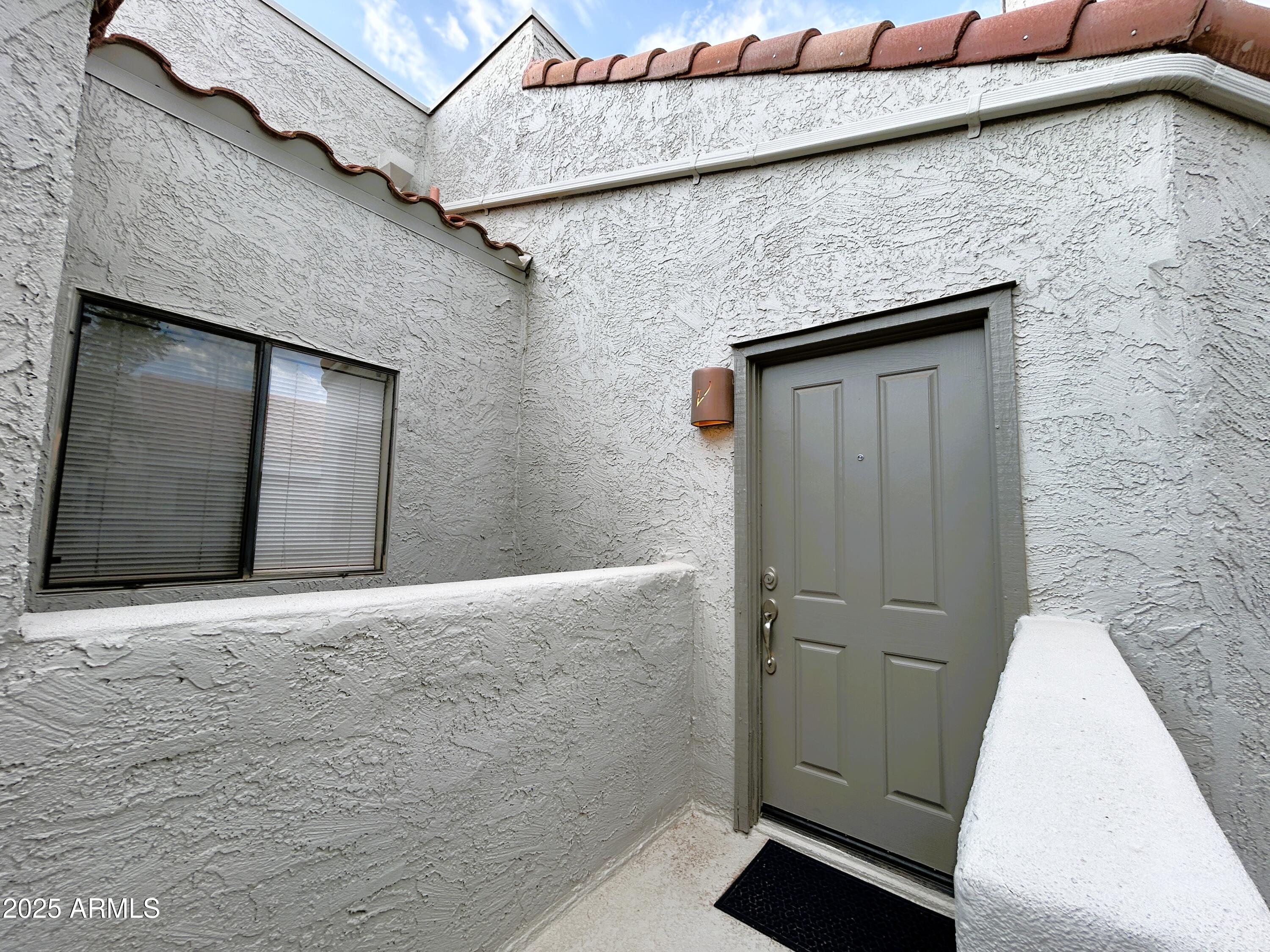 10055 East Mountainview Lake Drive, Unit 2059 Scottsdale, AZ 85258 - Photo 23 of 34 a brick house with a door