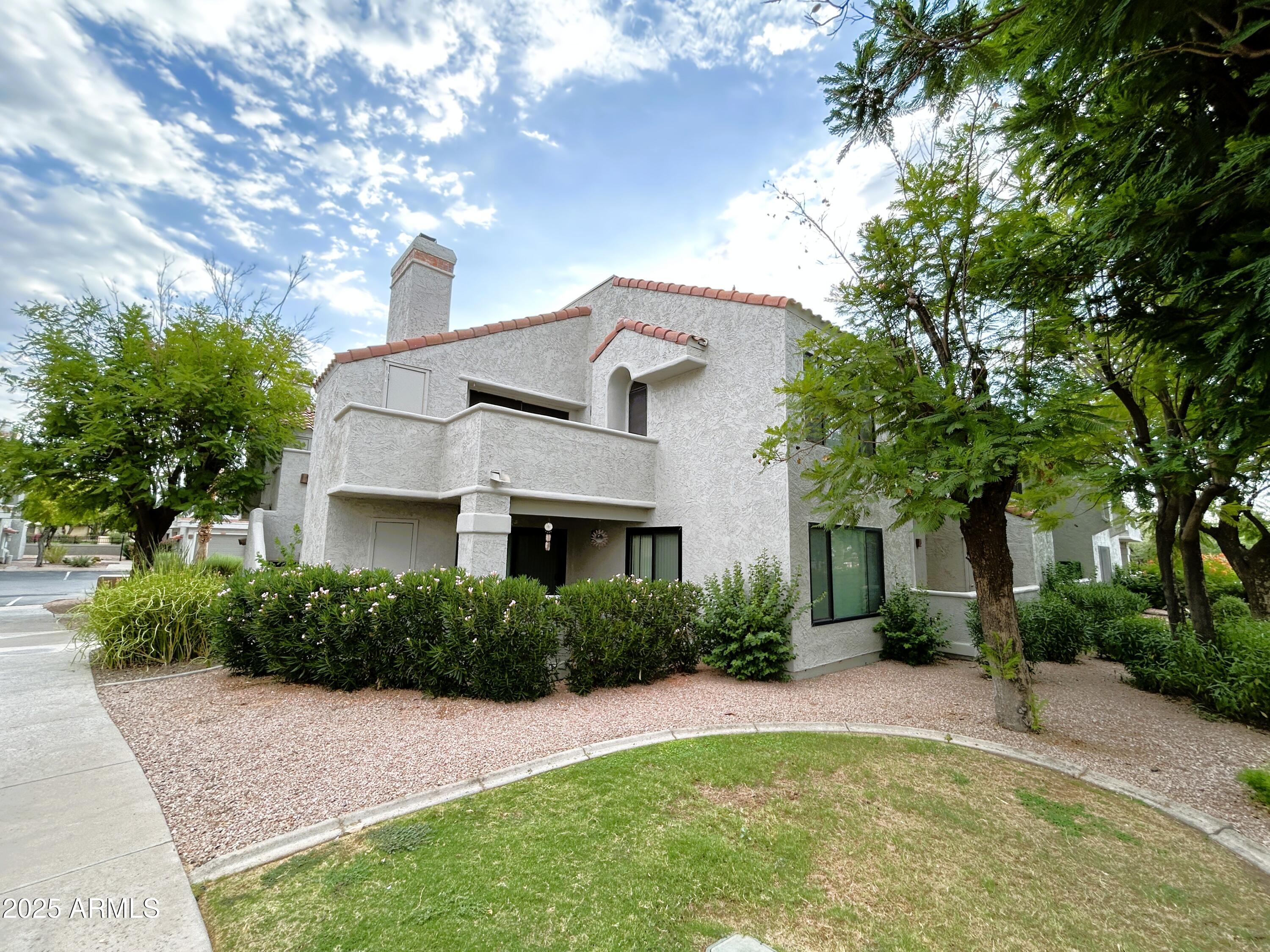 10055 East Mountainview Lake Drive, Unit 2059 Scottsdale, AZ 85258 - Photo 27 of 34 a front view of a house with a yard and garage