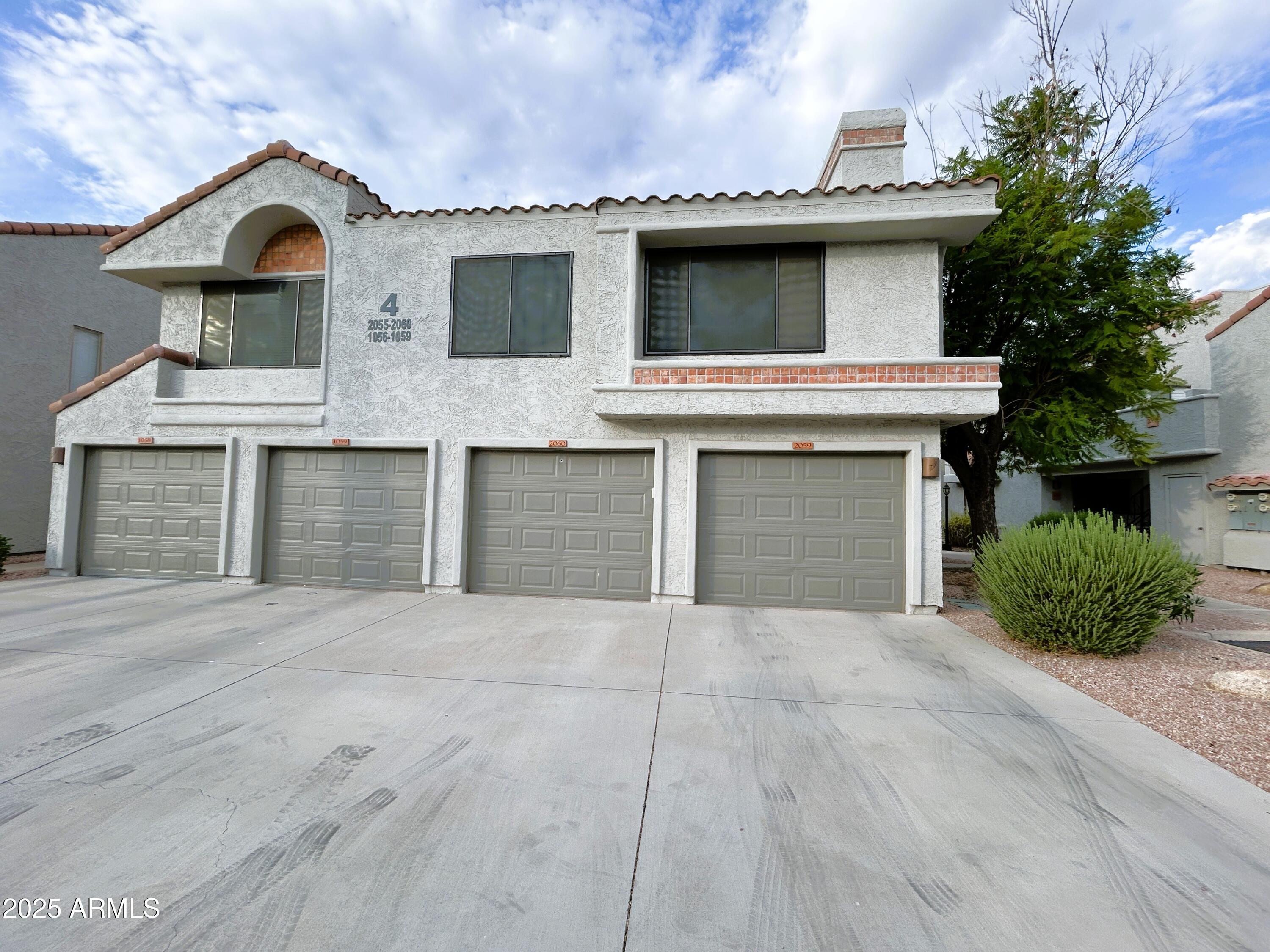 10055 East Mountainview Lake Drive, Unit 2059 Scottsdale, AZ 85258 - Photo 28 of 34 a front view of a house with yard and garage