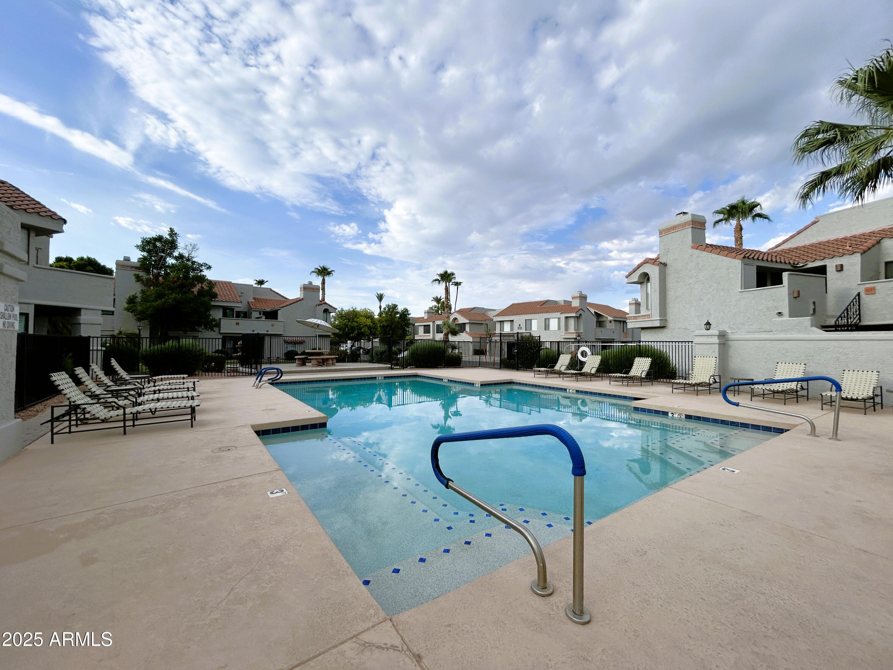 10055 East Mountainview Lake Drive, Unit 2059 Scottsdale, AZ 85258 - Photo 30 of 34 a swimming pool with outdoor seating and barbeque oven