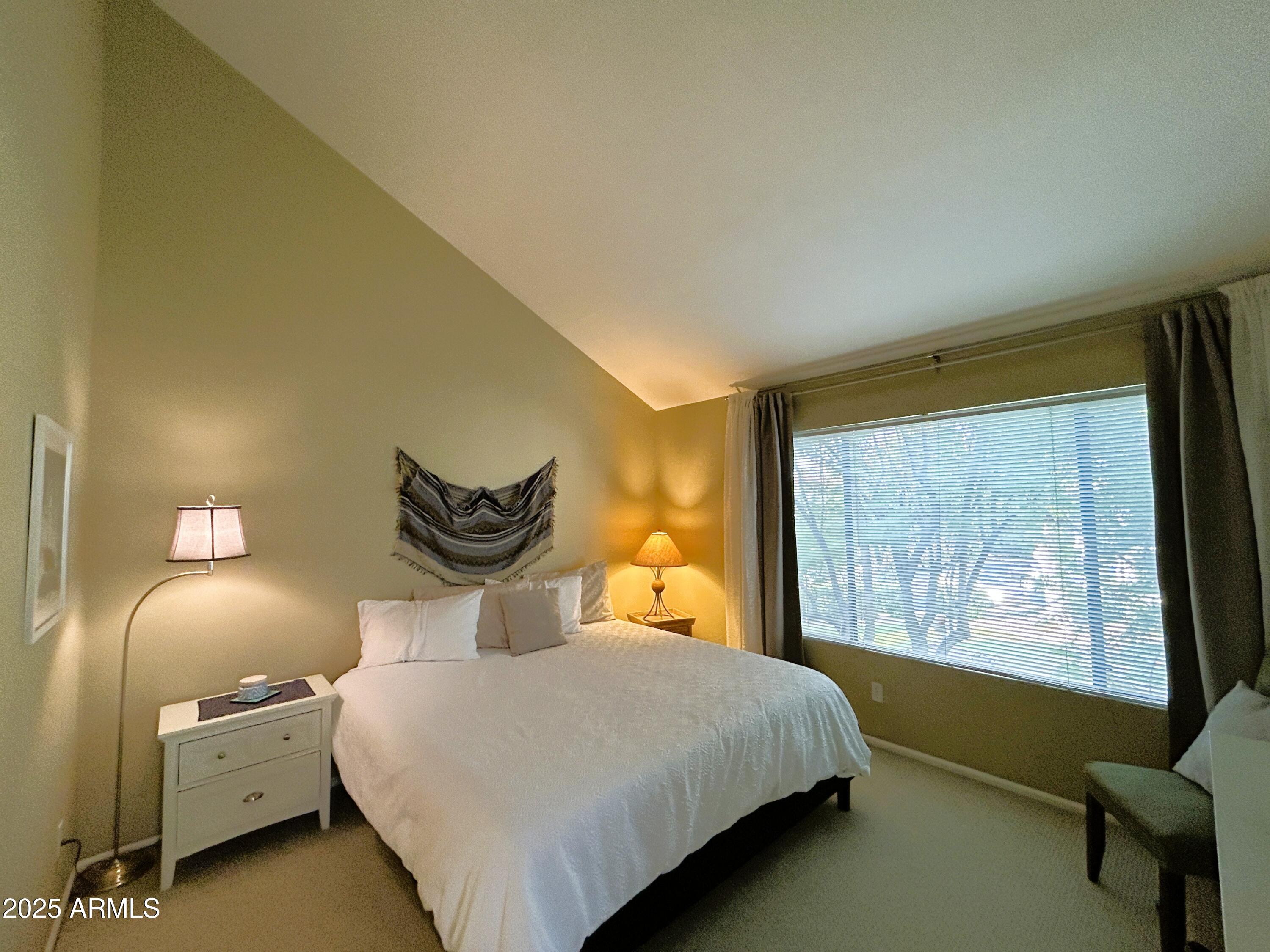 10055 East Mountainview Lake Drive, Unit 2059 Scottsdale, AZ 85258 - Photo 3 of 34 a bedroom with a bed and a painting on the wall