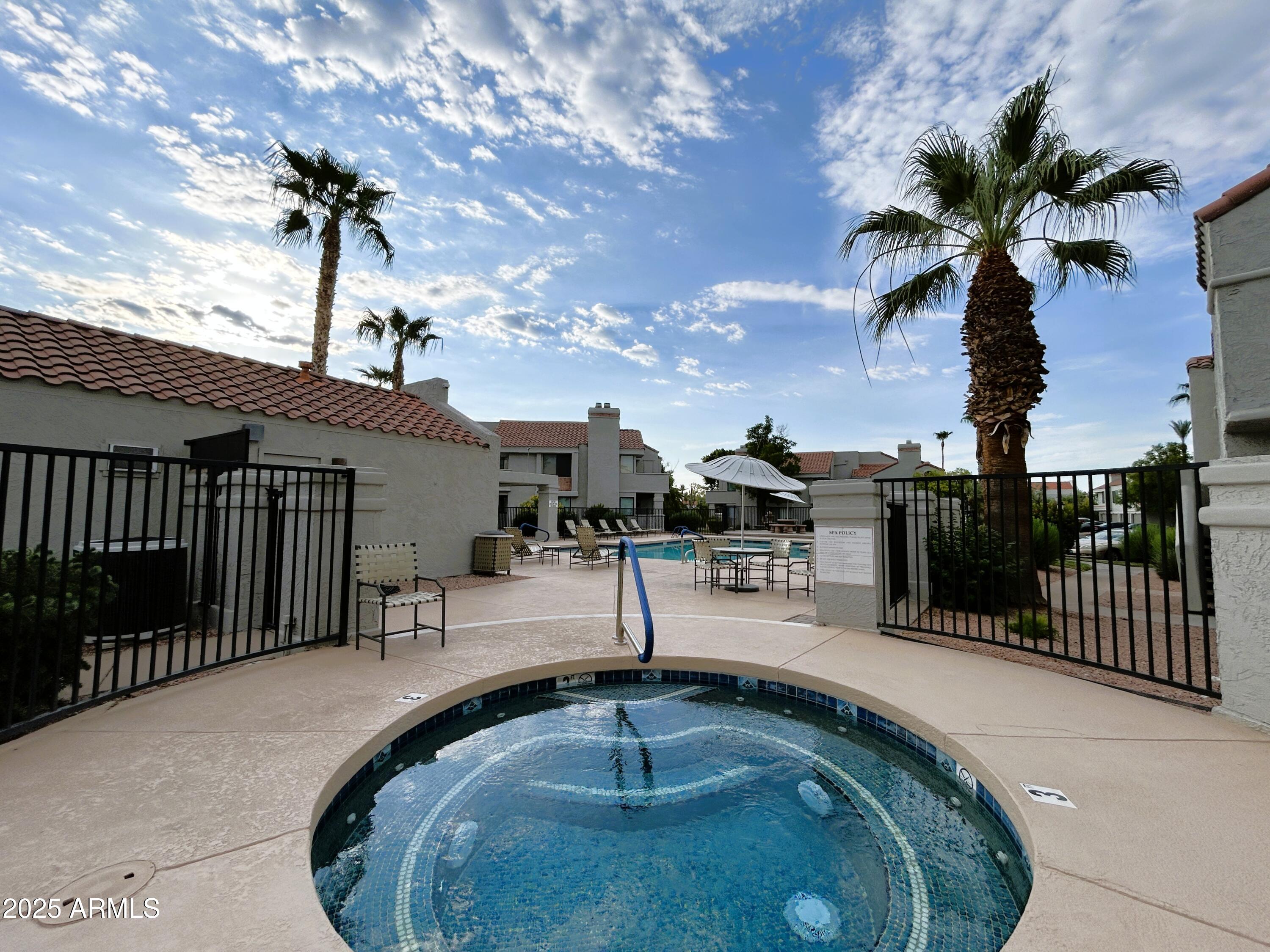 10055 East Mountainview Lake Drive, Unit 2059 Scottsdale, AZ 85258 - Photo 32 of 34 a swimming pool with outdoor seating and plants